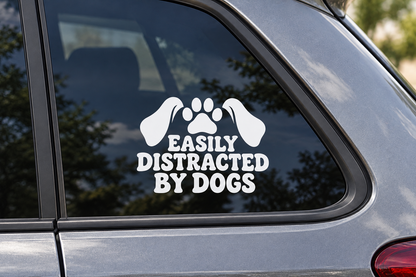 EASILY DISTRACTED BY DOGS contour cut car window decal shown in white