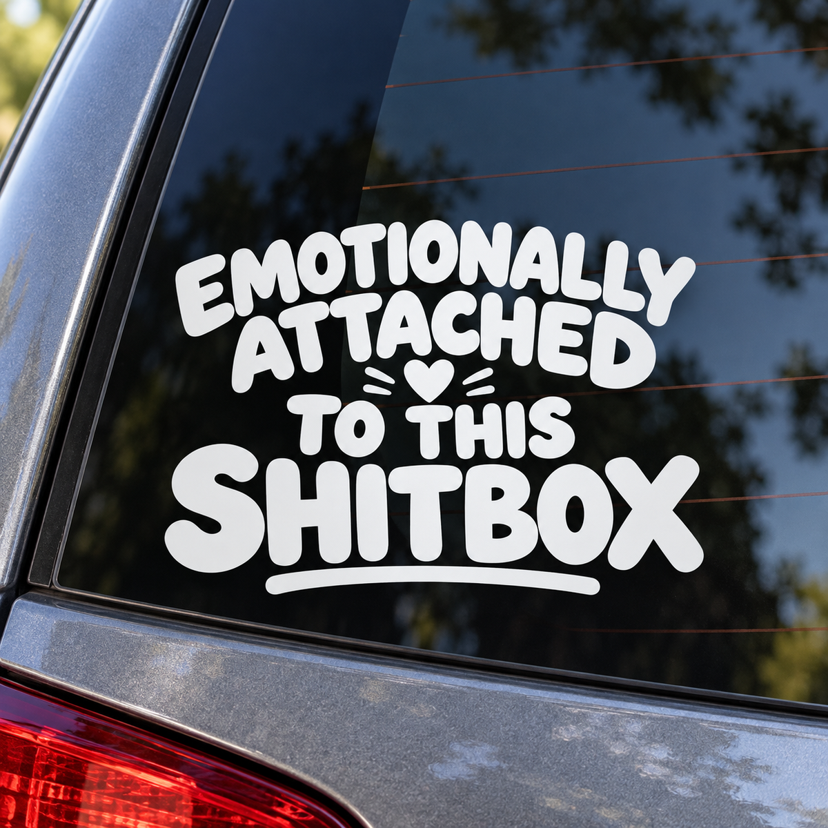 Emotionally Attached to This Shitbox white lettering on a car window