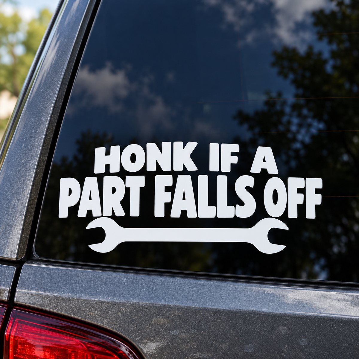 Honk If a Part Falls Off white lettering on a car window