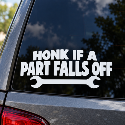 Honk If a Part Falls Off white lettering on a car window