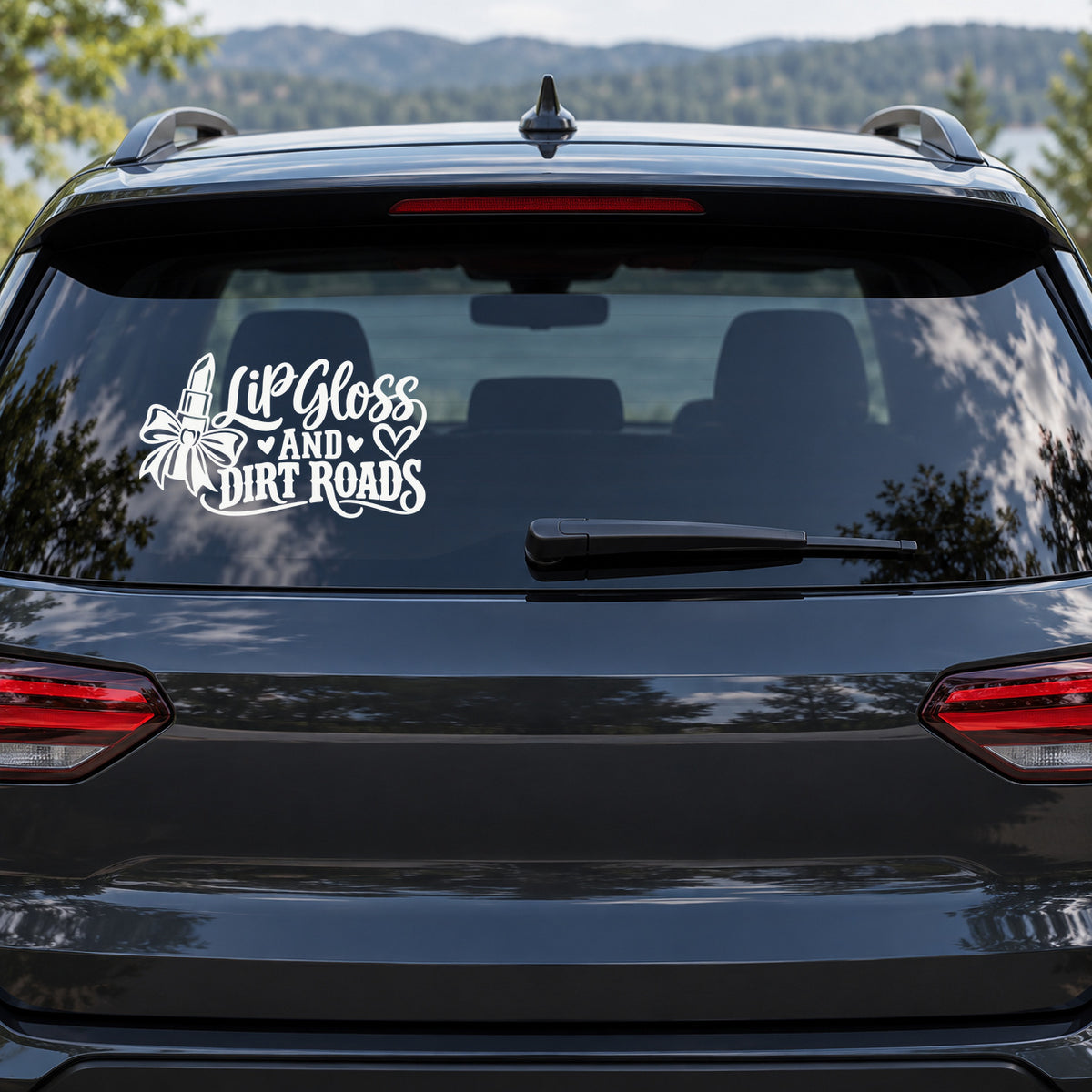 Lip Gloss and Dirt Roads Car Window Decal shown on a vehicle window