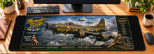Memphis Belle Victory Run Desk Mat in use on a warm wood office desk — overhead workspace view