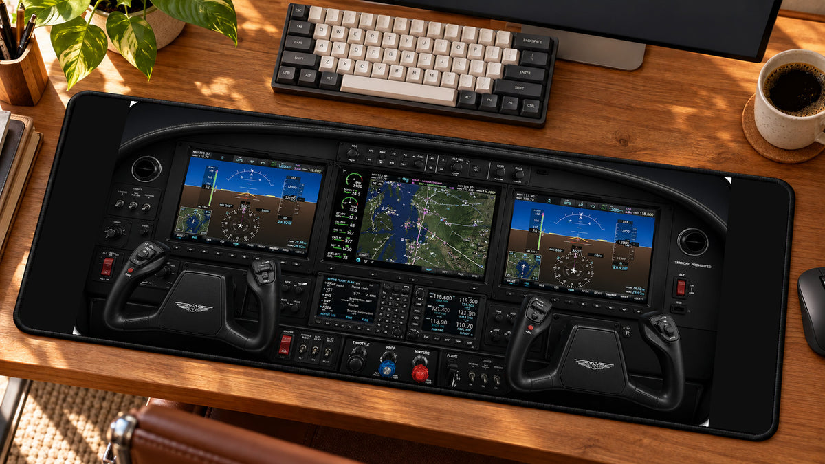 Modern Glass Cockpit Aviation Desk Mat in use on a warm wood office desk — angled workspace view