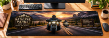 National Parks Road King Desk Mat in use on a warm wood office desk — overhead workspace view