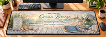 Ocean Breeze Coastal Calm Desk Mat in use on a warm wood office desk — overhead workspace view