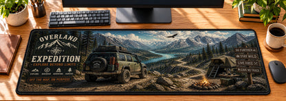 Overland Off-Road Expedition Desk Mat in use on a warm wood office desk — overhead workspace view