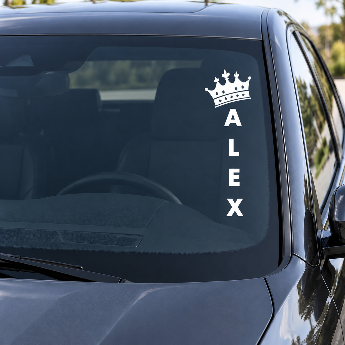 Ornate royal fleur-de-lis crown and vertical ALEX name in white on a car windshield