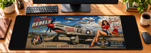 Runway Rebels Pin-Up Fighter Desk Mat in use on a warm wood office desk — overhead workspace view