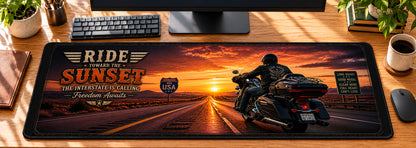 Sunset Interstate Cruiser Desk Mat in use on a warm wood office desk — overhead workspace view