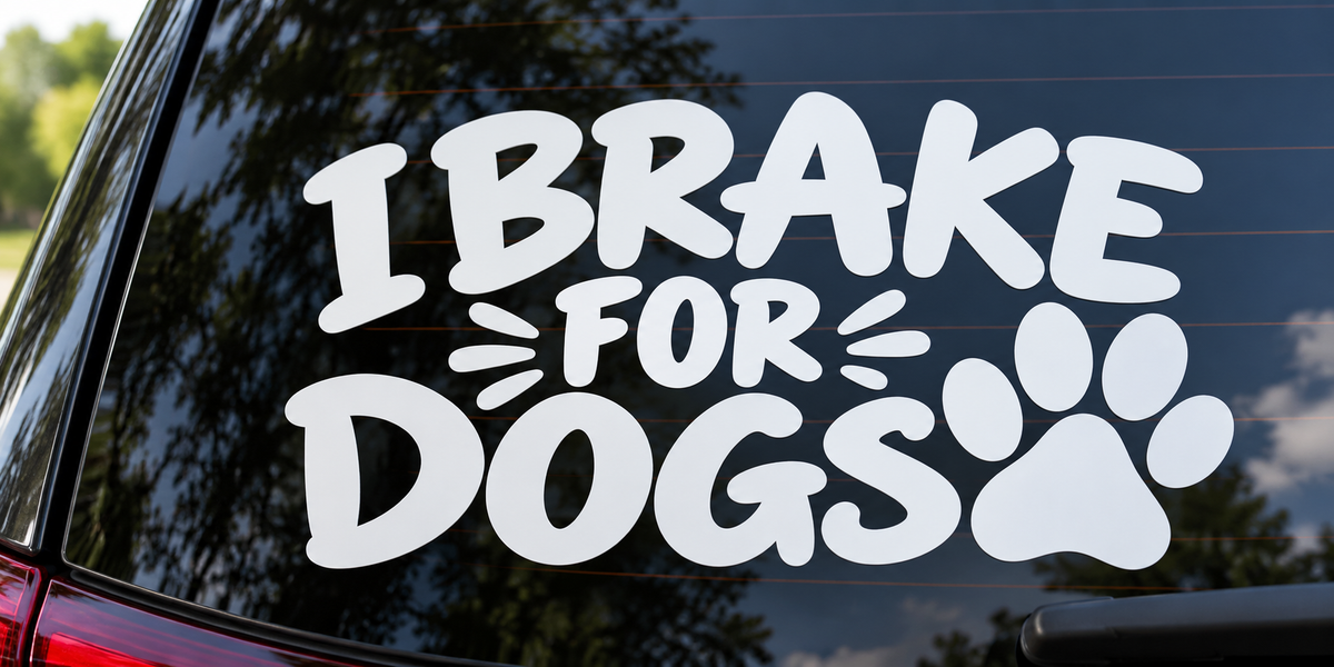 I Brake for Dogs Paw Print Funny Car Window Decal shown on a car window