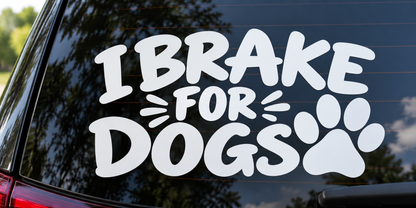 I Brake for Dogs Paw Print Funny Car Window Decal shown on a car window