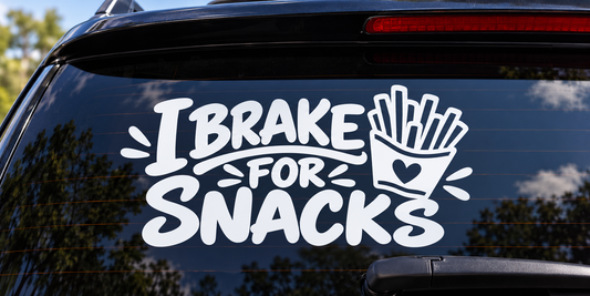 I Brake for Snacks Funny Car Window Decal shown on a car window